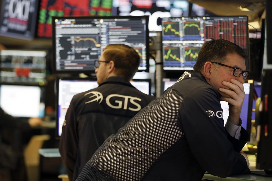 Specialist David Haubner, right, works on the floor of the New York Stock Exchange, Wednesday, March 11, 2020. Stocks are closing sharply lower on Wall Street, erasing more than 1,400 points from the Dow industrials, as investors wait for a more aggressive response from the U.S. government to economic fallout from the coronavirus. (AP Photo/Richard Drew)