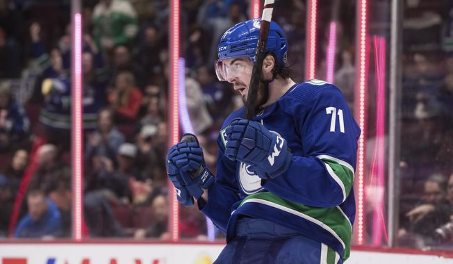 Vancouver Canucks&#x27; Zack MacEwan celebrates his goal against the New York Islanders during the second period of an NHL hockey game Tuesday, March 10, 2020, in Vancouver, British Columbia. (Darryl Dyck/The Canadian Press via AP)