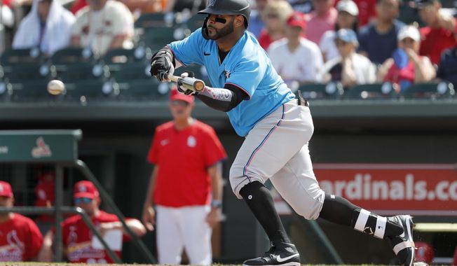Miami Marlins&#x27; Jonathan Villar hits a sacrifice bunt to score Francisco Cervelli during the third inning of a spring training baseball game Wednesday, Feb. 26, 2020, in Jupiter, Fla. (AP Photo/Jeff Roberson)