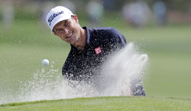 Adam Scott, of Australia, hits from a bunker on the ninth hole during a practice round for The Players Championship golf tournament, Wednesday, March 11, 2020, in Ponte Vedra Beach, Fla. (AP Photo/Lynne Sladky) ** FILE **