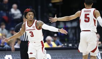 Arkansas guard Desi Sills (3) is congratulated by Jalen Harris (5) after Sills scored against Vanderbilt in the first half of an NCAA college basketball game in the Southeastern Conference Tournament Wednesday, March 11, 2020, in Nashville, Tenn. (AP Photo/Mark Humphrey)