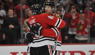Chicago Blackhawks&#39; Patrick Kane (88) celebrates with teammate Dominick Kubalik (8) of the Czech Republic, after defeating the San Jose Sharks 6-2 in an NHL hockey game Wednesday, March 11, 2020, in Chicago. (AP Photo/Paul Beaty)