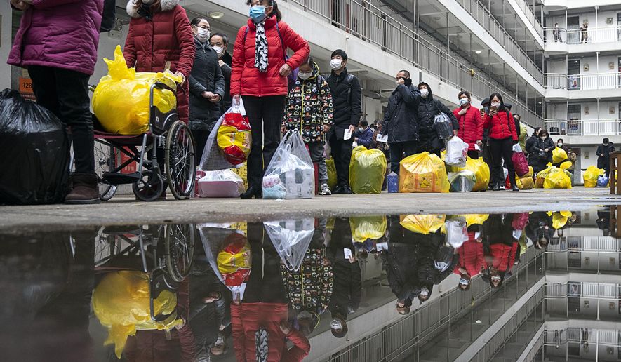 In this Tuesday, March 10, 2020, photo released by Xinhua News Agency, people recovered from coronavirus prepare to leave the rehabilitation center after a 14-day quarantine for medical observation in Wuhan in central China&#39;s Hubei province. The province at the center of China&#39;s virus outbreak is allowing factories and some other businesses to reopen in a new sign Beijing believes the disease that devastated its economy is being brought under control. (Xiong Qi/Xinhua via AP)