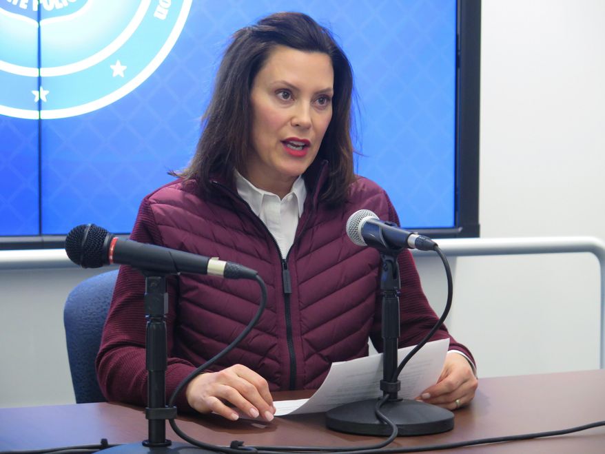 Michigan Gov. Gretchen Whitmer announces the state's first two cases of coronavirus, Tuesday, March 10, 2020, at the Michigan State Police headquarters in Windsor Township, Mich. She declared a state of emergency and urged residents to help slow the spread. Two people in the Detroit area have tested positive for the coronavirus infection, Michigan officials announced. A woman in Oakland County had traveled outside the country, while a man from Wayne County had traveled within the U.S., said Dr. Joneigh Khaldun, Michigan's medical executive. (AP Photo/David Eggert)