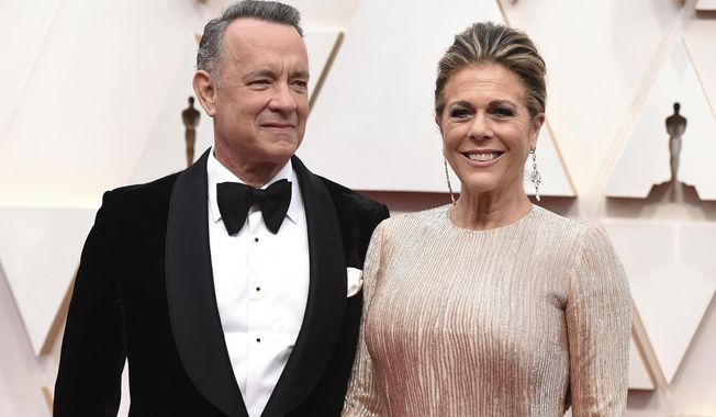 FILE - In this Feb. 9, 2020 file photo, Tom Hanks, left, and Rita Wilson arrive at the Oscars at the Dolby Theatre in Los Angeles. The couple have tested positive for the coronavirus, the actor said in a statement Wednesday, March 11. The 63-year-old actor said they will be &amp;quot;tested, observed and isolated for as long as public health and safety requires.&amp;quot; (Photo by Jordan Strauss/Invision/AP, File)