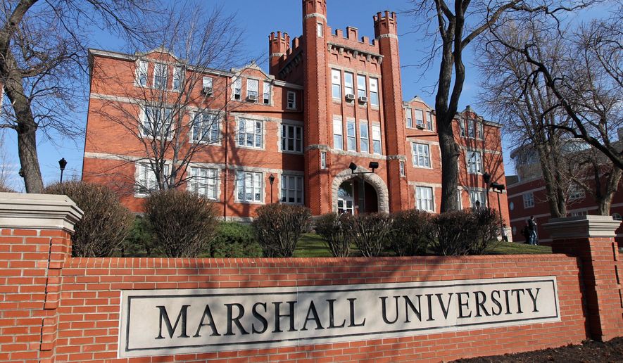 FILE - This Feb. 23, 2011 file photo shows the Marshall University Old Main exterior in Huntington, W.Va. The school will temporarily suspend in-person classes once students return from spring break in late March 2020 as it continues to monitor the threat of the new coronavirus in a state with no confirmed cases. (Lori Wolfe/The Herald-Dispatch via AP)