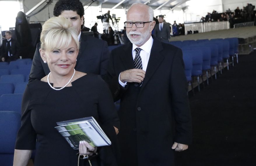 Televangelist Jim Bakker, right, walks with his wife Lori Beth Graham after a funeral service at the Billy Graham Library for the Rev. Billy Graham, who died last week at age 99, Friday, March 2, 2018, in Charlotte, N.C. (AP Photo/Chuck Burton) **FILE**
