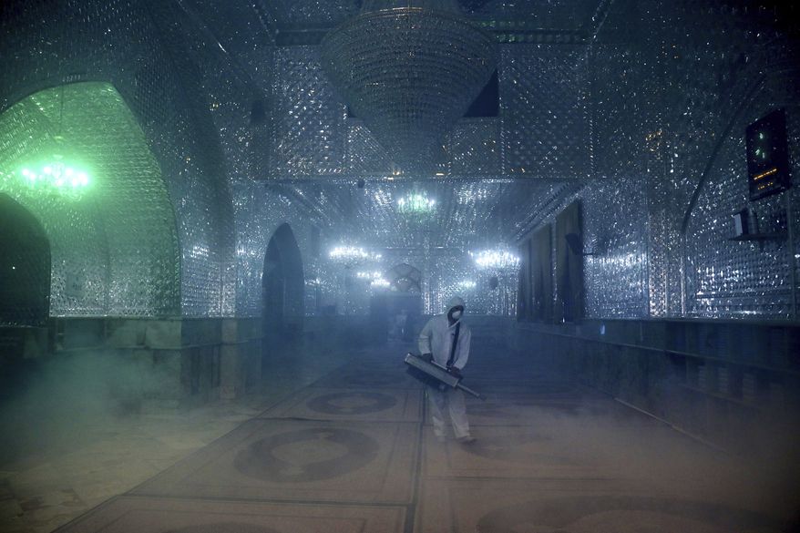 A firefighter disinfects the shrine of Saint Saleh to help prevent the spread of the new coronavirus in northern Tehran, Iran, Friday, March, 6, 2020. A Health Ministry spokesman warned authorities could use unspecified &quot;force&quot; to halt travel between major cities. (AP Photo/Ebrahim Noroozi)