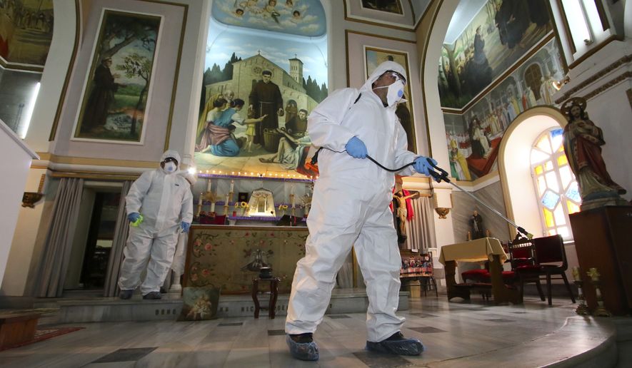 Workers wearing protective clothing disinfect St Antonio Church, in Bayrakli district of Izmir, Turkey, Thursday, March 12, 2020, as a precaution against the coronavirus. Turkey&#39;s Health Minister Fahrettin Koca announced the first case of COVID-19 coronavirus in Turkey on Wednesday. For most people, the new coronavirus causes only mild or moderate symptoms. For some it can cause more severe illness.(AP Photo/Emre Tazegul)