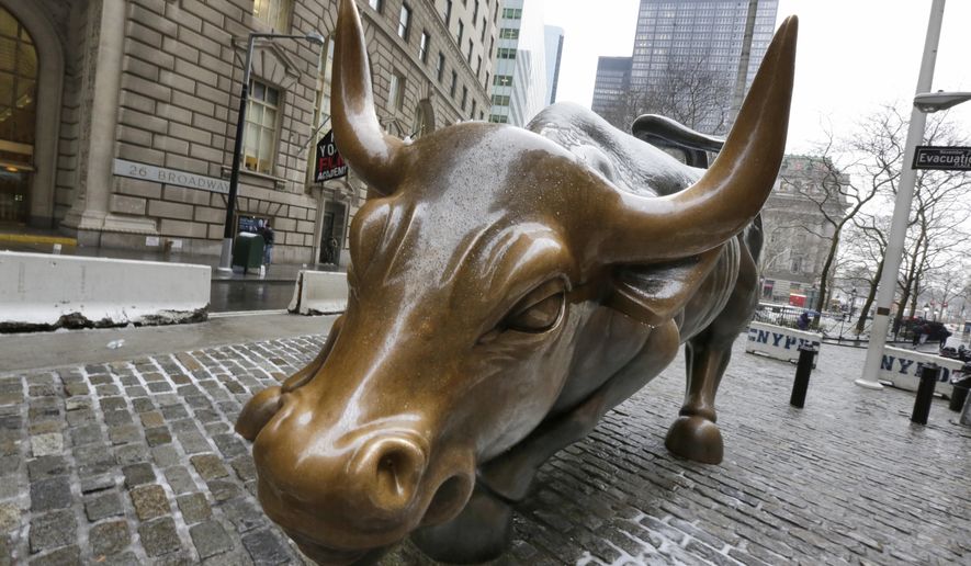 File-This Feb. 7, 2018, file photo shows the Charging Bull sculpture by Arturo Di Modica, in New York&#39;s Financial District. The longest bull market in U.S. history is over after nearly 11 years. The bull market officially ran from March 9, 2009, until Feb. 19, 2020, when it began the 20% dive that has taken it into bear market territory as of Thursday, March 12, 2020. (AP Photo/Richard Drew, File)