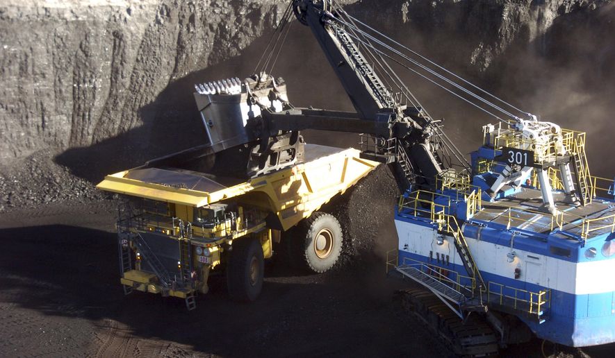 FILE - In this Nov. 15, 2016, file photo, a mechanized shovel loads coal from an 80-feet thick seam at the Spring Creek mine near Decker, Mont. Montana regulators reached a deal Thursday, March 12, 2020, allowing the state to enforce environmental laws at the mine after it was bought last year by a Navajo-owned company. (AP Photo/Matthew Brown, File)