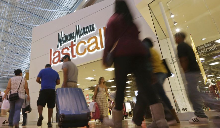 FILE - In this Nov. 25, 2016, file photo, shoppers walk by a Neiman Marcus Last Call department store in Miami. Neiman Marcus is ditching the off-price business and focusing on its high-end customers. The Dallas-based privately held luxury retailer said that it&#39;s closing more than half of its remaining 22 Last Call stores, which sold designer brands at big discounts. The company said the moves, which will result in 500 job cuts, are designed to free up resources to better focus on high-end customers. (AP Photo/Alan Diaz, File)