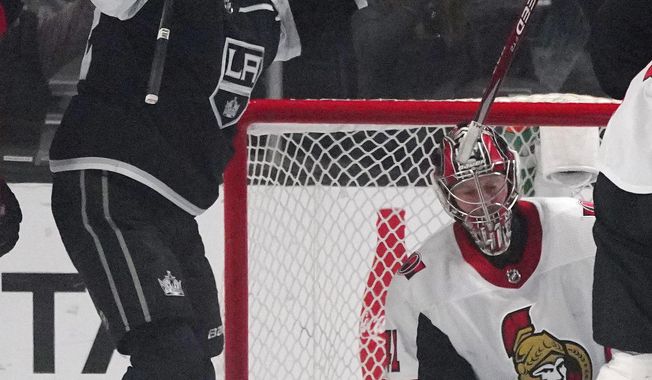 Los Angeles Kings center Trevor Lewis, left, celebrates his goal as Ottawa Senators goaltender Craig Anderson kneels at right during the first period of an NHL hockey game Wednesday, March 11, 2020, in Los Angeles. (AP Photo/Mark J. Terrill)