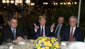 President Donald Trump speaks before a dinner with National Security Adviser Robert O&#39;Brien, right, and Brazilian President Jair Bolsonaro, left, at Mar-a-Lago, Saturday, March 7, 2020, in Palm Beach, Fla. (AP Photo/Alex Brandon)