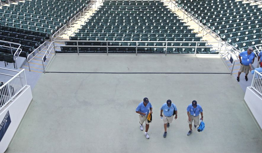 Ushers leave empty Hammond Stadium, after a baseball game between the Minnesota Twins and the Baltimore Orioles was canceled, Thursday, March 12, 2020, in Fort Myers, Fla. Major League Baseball has suspended the rest of its spring training game schedule because if the coronavirus outbreak. MLB is also delaying the start of its regular season by at least two weeks. (AP Photo/Elise Amendola)