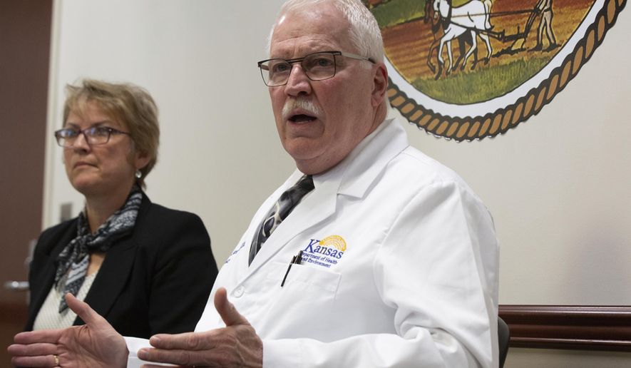 Lee Norman, Kansas Department of Health and Environment secretary, discusses with Mary Beverly, interim director of Johnson County's health agency, three confirmed cases of coronavirus that appeared in patients in Johnson County during a press conference Thursday, March 12, 2020 at KDHE headquarters in Topeka. (Evert Nelson/The Topeka Capital-Journal via AP)
