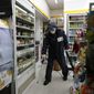 Members of the national reserve units wear protective gear as they disinfect against the new coronavirus at a convenient store in Seoul, South Korea, Thursday, March 12, 2020. For most people, the new coronavirus causes only mild or moderate symptoms, such as fever and cough. For some, especially older adults and people with existing health problems, it can cause more severe illness, including pneumonia. (AP Photo/Lee Jin-man)
