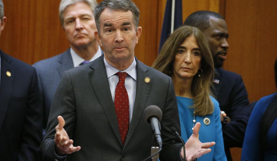 Virginia Gov. Ralph Northam, front, gestures during a news conference as House speaker Eileen Filler-Corn, right, and Secretary of Public safety Brian Moran, left, look on at the Capitol Thursday March 12 , 2020, in Richmond, Va. Northam declared a state of emergency due to the coronavirus outbreak. (AP Photo/Steve Helber)