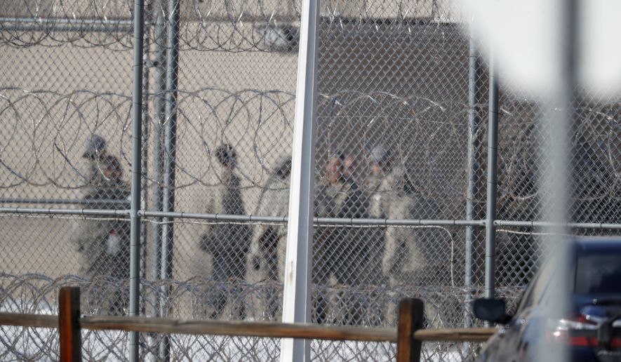 In this Feb. 18, 2020, file photo prisoners stand outside of the federal correctional institution in Englewood, Colo. Inmates at all 122 federal correctional facilities across the country will no longer be allowed visits from family, friends or attorneys for the next 30 days, in response to the threat of the coronavirus, officials told The Associated Press on Friday, March 13. (AP Photo/David Zalubowski, File)