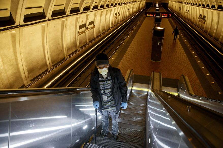 In this file photo, a Washington, D.C., man rides the escalator up at the Metro subway Congress Heights train station in Washington, Friday, March 13, 2020.  (AP Photo/Carolyn Kaster) ** FILE **