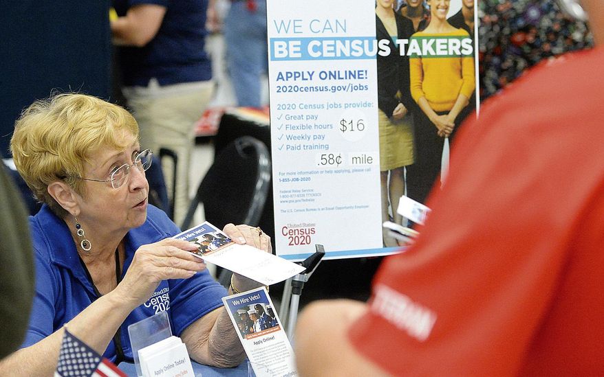 In this Oct. 2, 2019, file photo, Joyce Dalbey, left, with the U.S. Census Bureau, talks to attendees at the Yuma Community Job & Education Fair inside the Yuma Civic Center about possible job opportunities with the federal agency, in Yuma, Ariz. (Randy Hoeft/The Yuma Sun via AP) ** FILE **