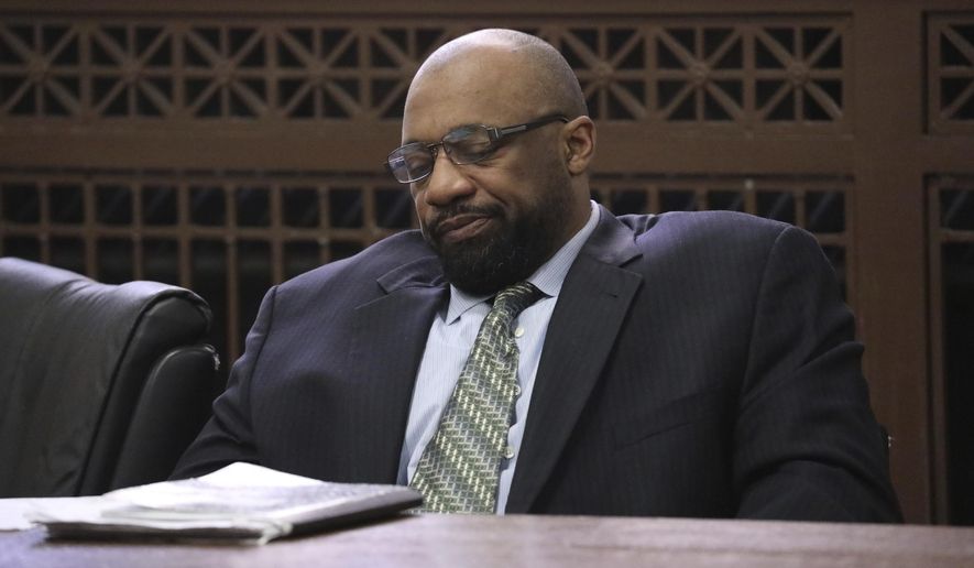 Shomari Legghette listens to attorneys during closing statements in his murder trial at the Leighton Criminal Courthouse, Friday, March 13, 2020, in Chicago. Legghette is on trial for first-degree murder in the Feb. 13, 2018, killing of Chicago Police Cmdr. Paul Bauer. (Antonio Perez/Chicago Tribune via AP)