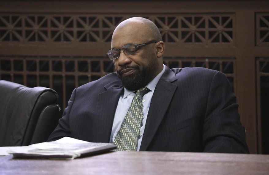 Shomari Legghette listens to attorneys during closing statements in his murder trial at the Leighton Criminal Courthouse, Friday, March 13, 2020, in Chicago. Legghette is on trial for first-degree murder in the Feb. 13, 2018, killing of Chicago Police Cmdr. Paul Bauer. (Antonio Perez/Chicago Tribune via AP)