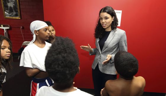In this photo from March 10, 2020, Morgan Harper, Democratic candidate for Ohio&#39;s 3rd Congressional District running against Democratic four-term incumbent Joyce Beatty, talks with End the Violence participants at Elite Boxing Gym in Columbus, Ohio. (AP Photo/Paul Vernon) ** FILE **
