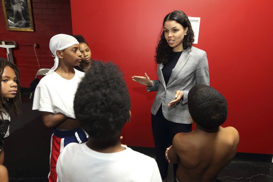 In this photo from March 10, 2020, Morgan Harper, Democratic candidate for Ohio&#39;s 3rd Congressional District running against Democratic four-term incumbent Joyce Beatty, talks with End the Violence participants at Elite Boxing Gym in Columbus, Ohio. (AP Photo/Paul Vernon) ** FILE **