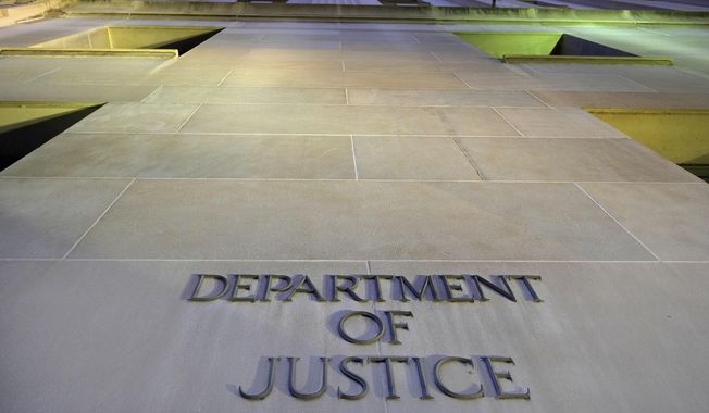 In this May 14, 2013, file photo, the Department of Justice headquarters building in Washington is photographed early in the morning. The Executive Office for Immigration Review is the arm of the Justice Department that oversees deportation proceedings whether immigrants are allowed stay in the U.S. or whether they are turned back to their countries. (AP Photo/J. David Ake, File)