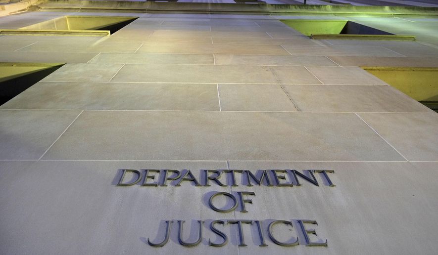 In this May 14, 2013, file photo, the Department of Justice headquarters building in Washington is photographed early in the morning. The Executive Office for Immigration Review is the arm of the Justice Department that oversees deportation proceedings whether immigrants are allowed stay in the U.S. or whether they are turned back to their countries. (AP Photo/J. David Ake, File)