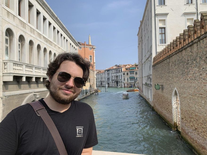 This 2019 photo shows Duncan Lemp in Venice, Italy. Lemp was asleep in his bedroom when police opened fire from outside his house, killing him and wounding his girlfriend, an attorney for the 21-year-old man’s family said Friday, March 13, 2020. (Mercedes Lemp via AP)