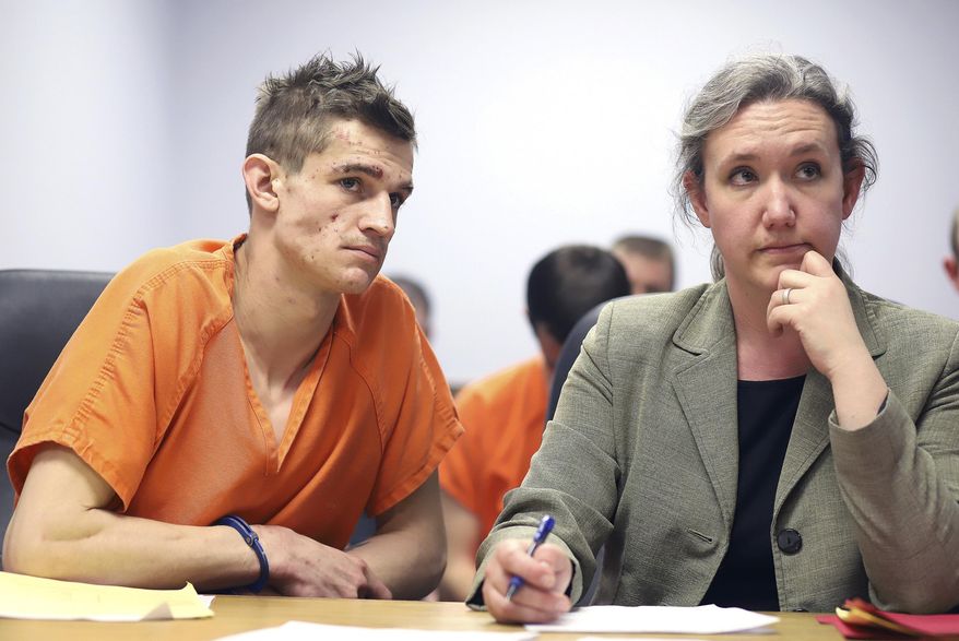 In this photo taken Thursday, March 12, 2020, Logan Dallas Christopher, 25, of Stevensville, Mont. is formally charged with killing the mother of his two young children and his own mother at a hearing in Ravalli County Justice Court in Hamilton, Mont. His bail was set at $2 million and he did not enter a plea. Christopher was represented by public defender Sarah Busch, who asked that his bail be set at $100,000. (Perry Backus/Ravalli Republic via AP)
