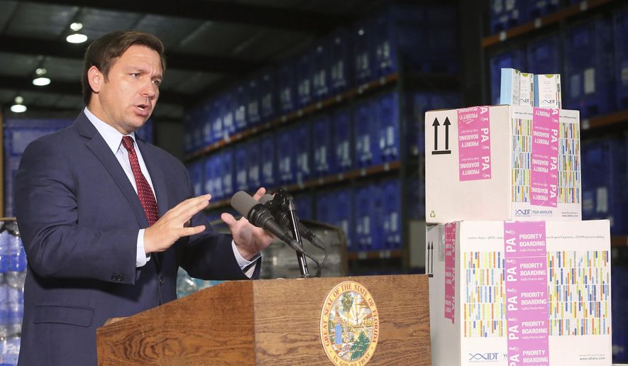 Florida Gov. Ron DeSantis speaks at a news conference at an emergency management warehouse alongside props of testing kits about the spread of the coronavirus, Friday March 13, 2020 in Tallahassee, Fla. The vast majority of people recover from the new coronavirus. According to the World Health Organization, most people recover in about two to six weeks, depending on the severity of the illness. ((AP Photo/Steve Cannon)