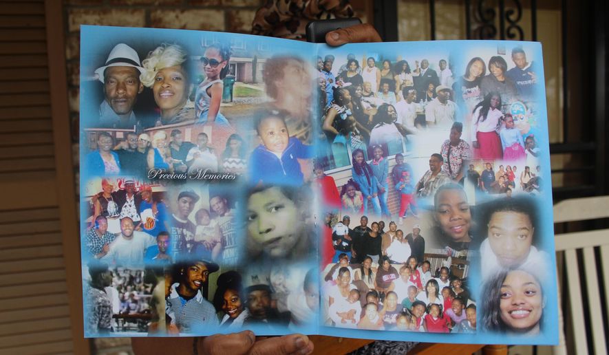 In this April 12, 2020 photo.Teresa Brown holds a pamphlet in Greenwood, Miss. that was distributed during the funeral for Walter Stewart Jr. The pamphlet featured a collage of images show Stewart with friends and family. Stewart's slain body was discovered in Sidon Cutoff Lake by a fisherman on April 12, 2019. (Gerard Edic/The Commonwealth via AP)