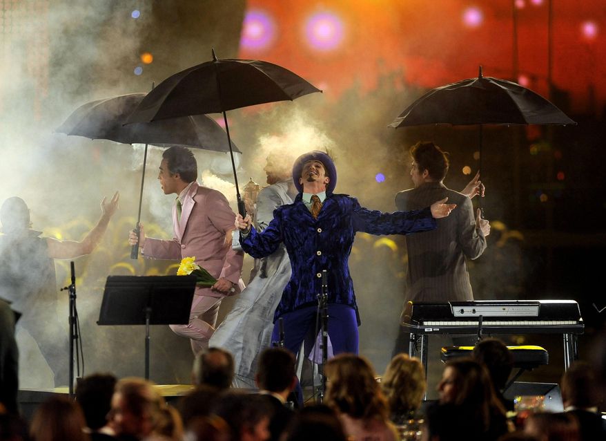 FILE - In this Feb. 10, 2012, file photo, members of the cast from The Beatles "LOVE" by Cirque du Soleil perform at the MusiCares Person of the Year gala honoring Paul McCartney in Los Angeles. Cirque du Soleil, creator of many of the most popular shows in Las Vegas, said Saturday, March 14, 2020, that it is temporarily suspending its productions in Las Vegas as well as around the world because of the new coronavirus outbreak. (AP Photo/Chris Pizzello, File)