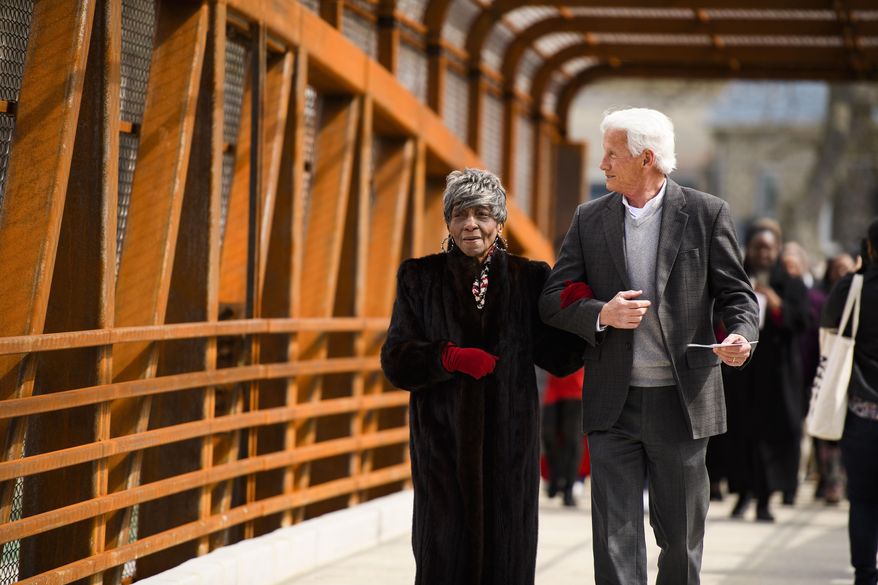 Greenville County councilwoman Xanthene Norris, left, walks across the Hampton Avenue Bridge for the first time with county administrator Joe Kernell during a dedication event Friday, March 6, 2020. (Josh Morgan/The Independent-Mail via AP)