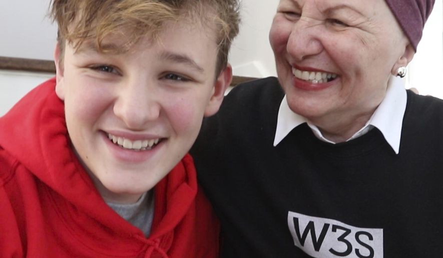 Wes Selby,12, from Naperville, Ill. is selling a gym shoe he designed to benefit pancreatic cancer research. Wes is raising money for the Pancreatic Cancer Action Network since his grandmother, Arlene "Lee Lee"Tellis was diagnosed last year. The shoe, sold under the W3S brand, features red, white and blue and a subtle nod to a man on the moon with an image on the tongue. It's a nod to his grandmother who says "I love you to the moon and back." (Patrick Kunzer/Daily Herald via AP)