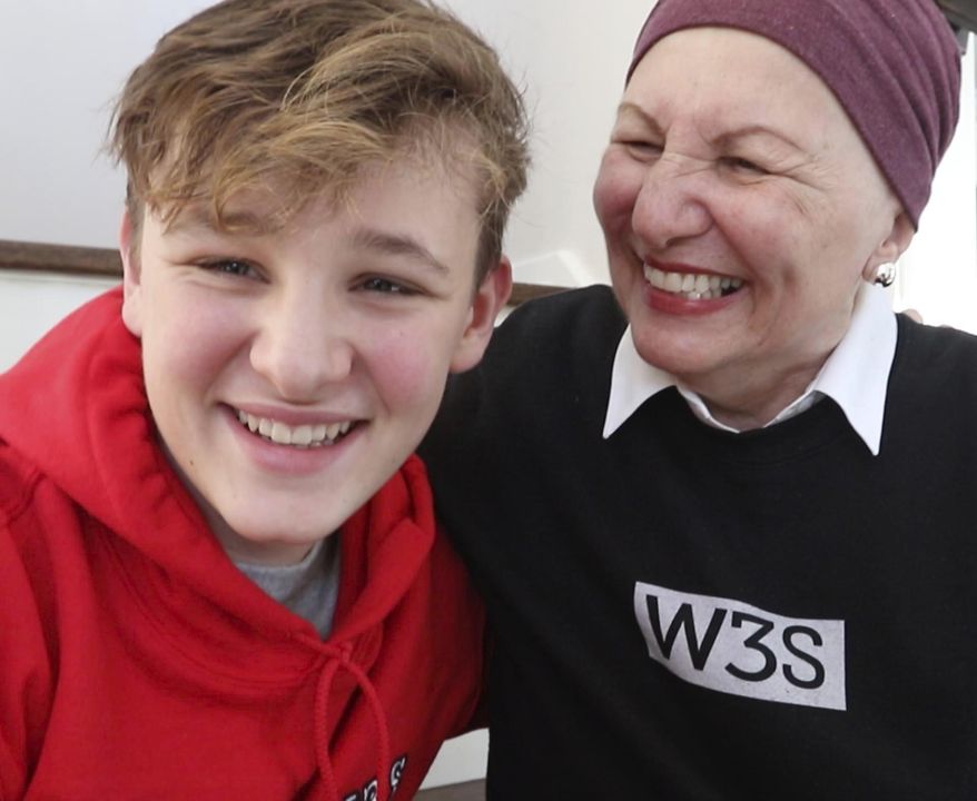 Wes Selby,12, from Naperville, Ill. is selling a gym shoe he designed to benefit pancreatic cancer research. Wes is raising money for the Pancreatic Cancer Action Network since his grandmother, Arlene "Lee Lee"Tellis was diagnosed last year. The shoe, sold under the W3S brand, features red, white and blue and a subtle nod to a man on the moon with an image on the tongue. It's a nod to his grandmother who says "I love you to the moon and back." (Patrick Kunzer/Daily Herald via AP)