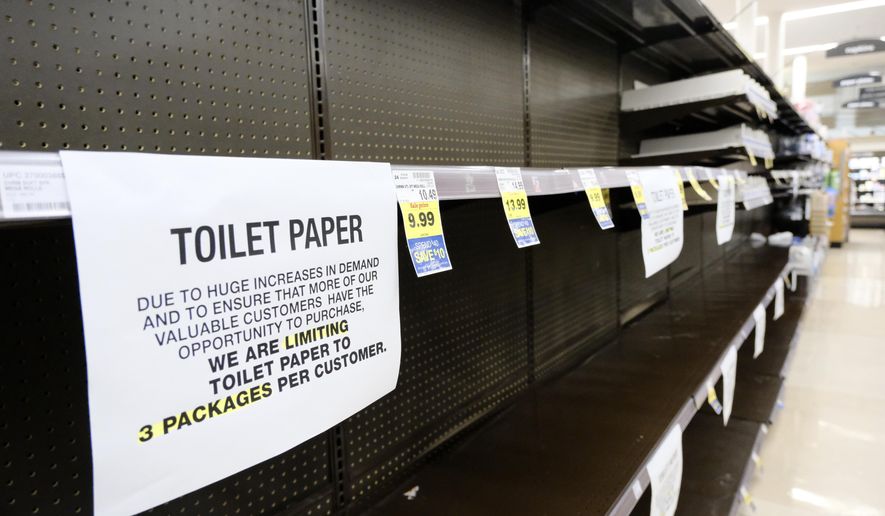 A notice limiting only 3 packages of toilet paper per customer is displayed on picked bare shelves after shoppers cleaned out the stock of paper and cleaning products at a local grocery store in Burbank, Calif. on Saturday, March 14, 2020. Californians wanting to escape the new reality of the coronavirus at the movies, casino or amusement park are running into the six foot rule. State health officials issued new guidance Saturday urging theaters to keep attendance under 250 people and ask strangers to sit six feet apart. (AP Photo/Richard Vogel)