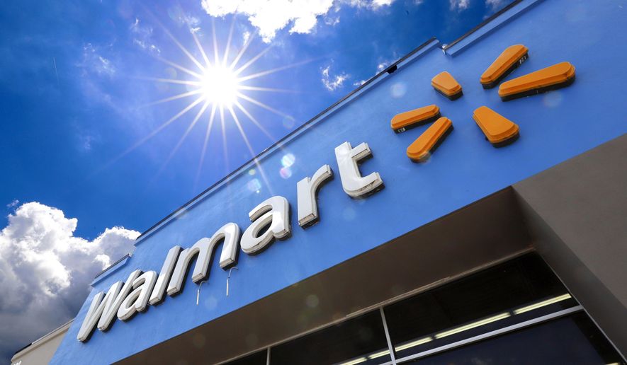 FILE - This June 25, 2019, file photo shows the entrance to a Walmart in Pittsburgh. Walmart, the nation’s largest retailer and private employer, said late Saturday, March 14, 2020, it is limiting store hours to ensure they can keep sought-after items such as hand sanitizer in stock amid the coronavirus pandemic. (AP Photo/Gene J. Puskar, File)