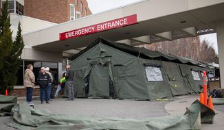 Hospitals across the countries are responding to the spread of the coronavirus by testing patients in circus-like triage tents, having them wait in their cars or creating separate entrances. (ASSOCIATED PRESS)