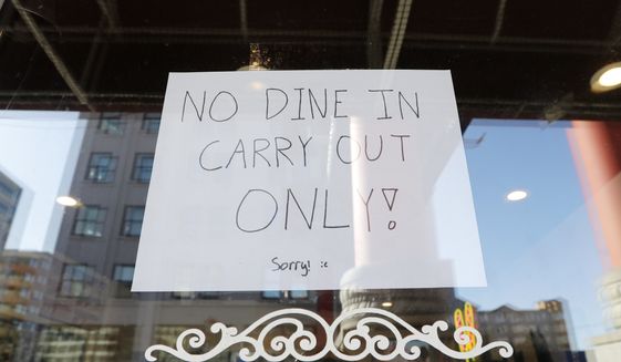A sign posted in a restaurant window in the Chinatown-International District advises of only take out orders Monday, March 16, 2020, in Seattle. Washington Gov. Jay Inslee on Monday ordered all bars, restaurants, entertainment and recreation facilities to temporarily close to fight the spread of the new coronavirus in the state with by far the most deaths in the U.S. from the COVID-19 disease. Take out and delivery food orders are still allowed. (AP Photo/Elaine Thompson)