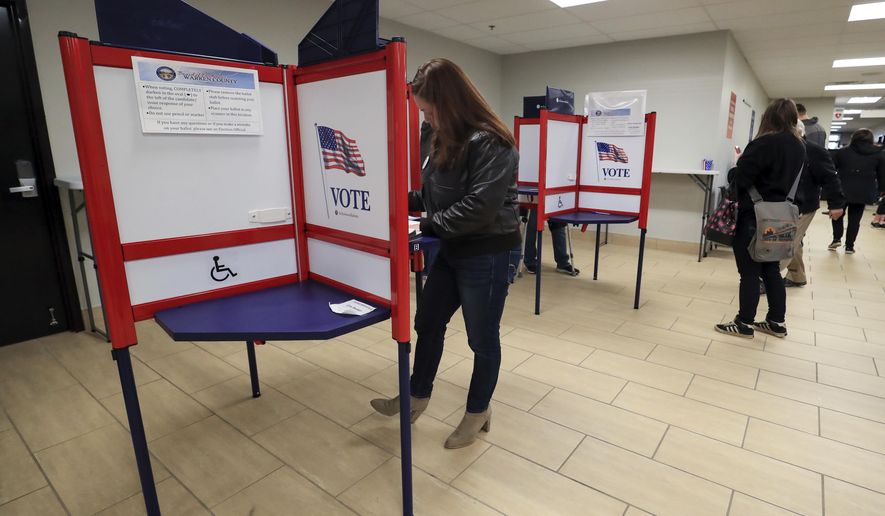 Nikki Foster, democratic candidate for Ohio's first congressional district, votes early at the Warren County Board of Elections, Saturday, March 14, 2020, in Lebanon, Ohio. (AP Photo/Aaron Doster)