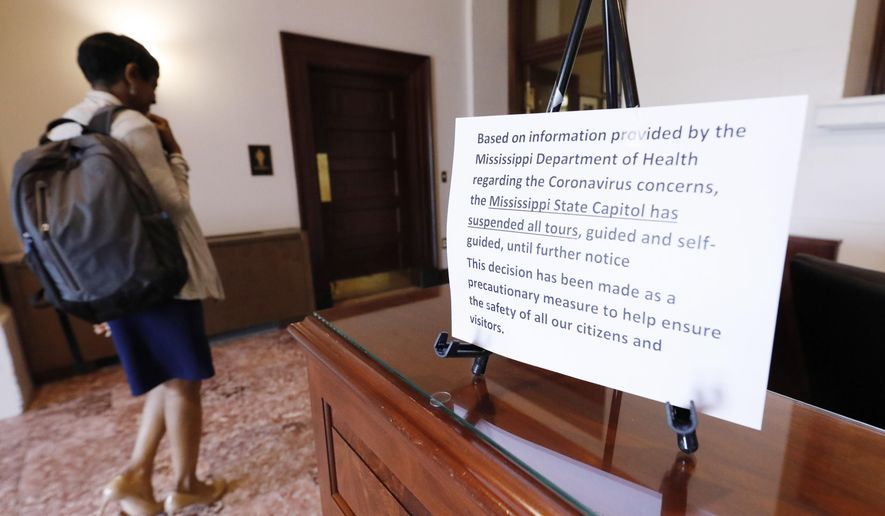 Sen. Tammy Felder Witherspoon, D-Magnolia, enters the Capitol in Jackson, Miss., Monday, March 16, 2020, as lawmakers ready for another week of the Legislature. Cleaning crews gave the working facility an extra wipe down prior to lawmakers returning Monday afternoon for another week of the Legislature. Concerns about the COVID-19 virus has made disinfecting a priority, and all guided and self-guided tours have been suspended until further notice. (AP Photo/Rogelio V. Solis)