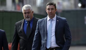 Convicted ex-Rep. Duncan Hunter, right, leaves a court building after sentencing Tuesday, March 17, 2020, in San Diego. Hunter has been sentenced to 11 months in prison after pleading guilty to misspending campaign funds. (AP Photo/Gregory Bull)