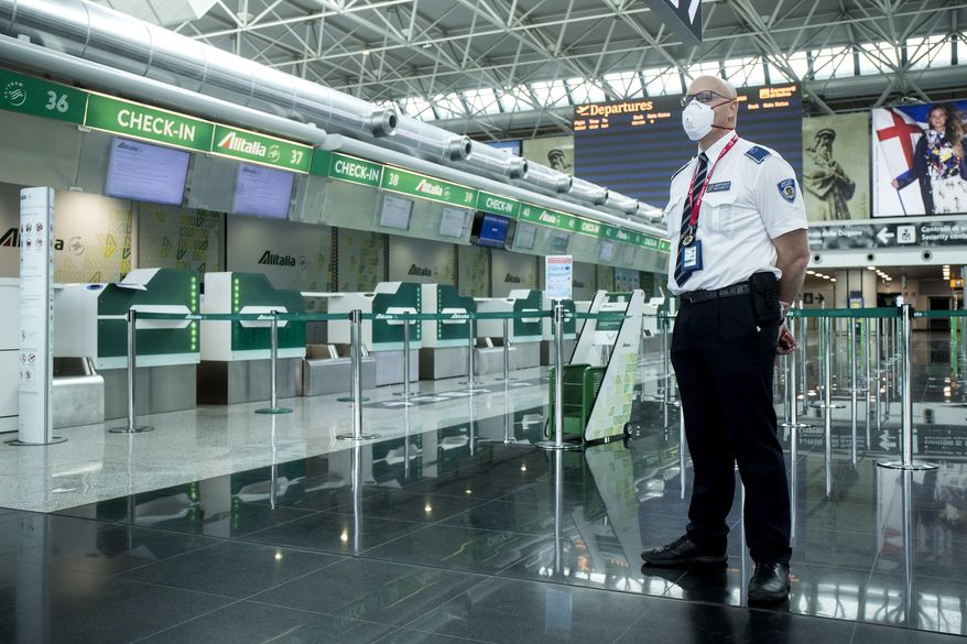 A view of terminal 1 of the Leonardo Da Vinci airport, that was closed due to the reduced transit caused by the coronavirus outbreak, in Rome, Tuesday, March 17, 2020. For most people, the new coronavirus causes only mild or moderate symptoms. For some it can cause more severe illness, especially in older adults and people with existing health problems.(Roberto Monaldo/LaPresse via AP)