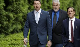 Convicted ex-Rep. Duncan Hunter, left, walks towards a court building for sentencing Tuesday, March 17, 2020, in San Diego. Hunter faces up to five years in prison after pleading guilty on a corruption charge. Hunter served six terms representing one of Southern California&#39;s last solidly Republican districts before he resigned. (AP Photo/Gregory Bull)
