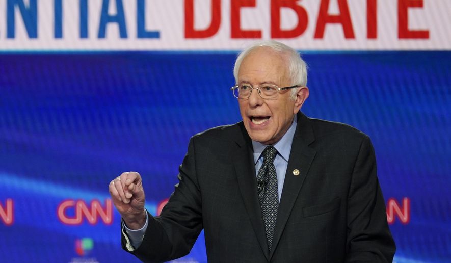 In this Sunday, March 15, 2020, photo, Sen. Bernie Sanders, I-Vt., with former Vice President Joe Biden, speaks during a Democratic presidential primary debate at CNN Studios in Washington. (AP Photo/Evan Vucci) ** FILE **
