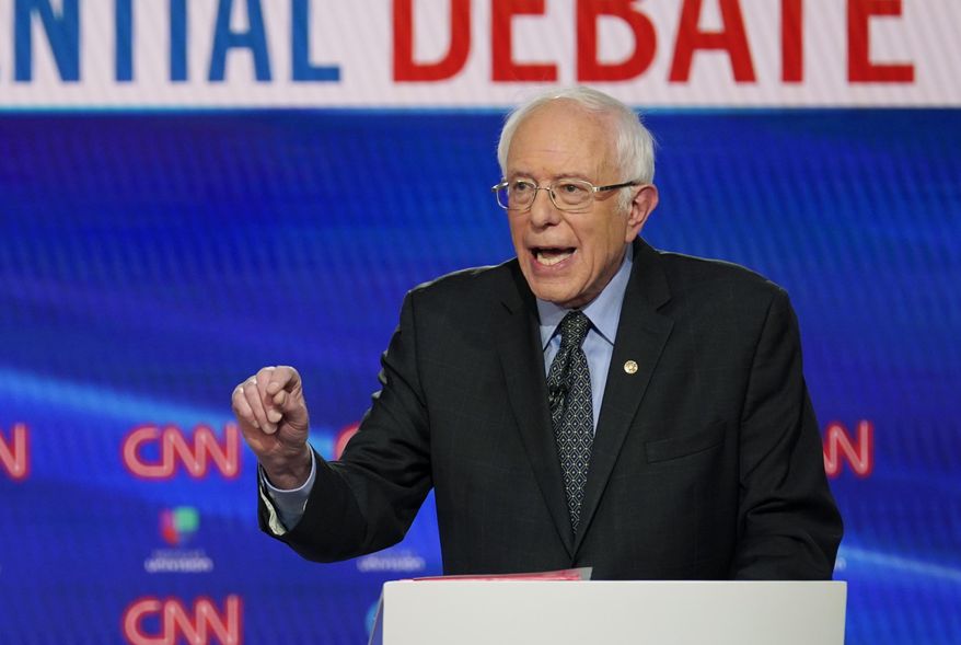 In this Sunday, March 15, 2020, photo, Sen. Bernie Sanders, I-Vt., with former Vice President Joe Biden, speaks during a Democratic presidential primary debate at CNN Studios in Washington. (AP Photo/Evan Vucci) ** FILE **